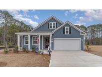 Charming single-Gathering home showcasing craftsman-style architecture, a two-car garage, and a welcoming front porch at 597 Haven View Way, Murrells Inlet, SC 29576