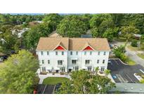 Modern townhome with a neutral color palette, red accents, and ample parking at 6606 Wildwood Trail # E, Myrtle Beach, SC 29572