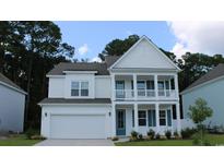 Charming two-story home with a front porch and well-manicured lawn at 709 Choctaw Dr., Conway, SC 29526