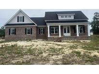 Beautiful brick home with white pillars on the front porch and black shutters at 713 Horry Rd., Conway, SC 29526