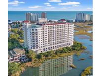 Beautiful exterior view of the building overlooking a marsh and the ocean at 9547 Edgerton Dr. # 204, Myrtle Beach, SC 29572