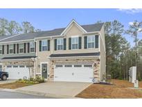 Charming townhome with stone accents, a two-car garage, and lush landscaping at 101 Galil Dr. # A, Myrtle Beach, SC 29579