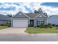 Charming single-story home with a two-car garage and well-manicured lawn at 1182 Palm Crossing Dr., Little River, SC 29566