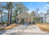 Charming single Gathering home featuring a welcoming front porch and large driveway at 170 Minnow Dr., Pawleys Island, SC 29585