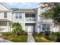 Charming two-story townhome with a private balcony and well-manicured landscaping at 1826 Low Country Pl. # E, Myrtle Beach, SC 29577