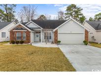 Charming single-story home with a well-manicured lawn and a brick-accented facade at 199 Glenwood Dr., Conway, SC 29526