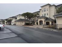 A condo complex with lush landscaping featuring palm trees and convenient parking spaces out front at 2180 Waterview Dr. # 421, North Myrtle Beach, SC 29582