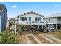 Charming raised beach house with a spacious deck, RV parking, and inviting curb appeal at 315 60Th Ave. N, North Myrtle Beach, SC 29582