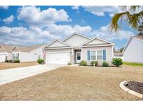 Charming single-story home featuring a well-maintained lawn and attached two-car garage at 321 Rycola Circle, Surfside Beach, SC 29575