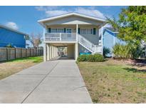 Charming beach house featuring elevated design, front porch and covered parking at 342 Dogwood Dr. S, Murrells Inlet, SC 29576