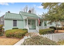 Charming home featuring a quaint front porch with an American flag and manicured landscaping at 4413 Bed Straw Ct., Murrells Inlet, SC 29576