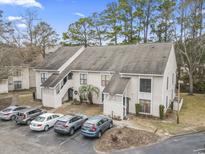 Beautiful two-story condo featuring four assigned parking spaces, a private entrance and mature trees at 4502 Little River Inn Ln. # 2507, Little River, SC 29566