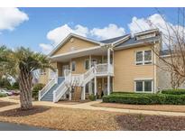 Charming condo with tan siding, white trim, and inviting front staircase at 4515 Lighthouse Dr. # 25B, Little River, SC 29566