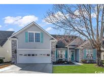 Charming two-story home with gray siding, stone accents, and a well-manicured lawn at 537 Sand Ridge Rd., Conway, SC 29526