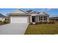 Charming single-story home featuring stone accents, a two-car garage, and manicured front lawn at 538 Haven View Way, Murrells Inlet, SC 29576