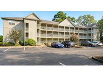 Attractive condo building with multiple levels and balconies, surrounded by well-maintained landscaping at 922 Fairwood Lakes Ln. # 22M, Myrtle Beach, SC 29588