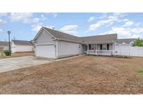 Charming one-story home with gray siding, attached garage, and inviting front porch, perfect for enjoying the neighborhood at 9545 Sullivan Dr., Murrells Inlet, SC 29576