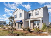 Charming two-story home featuring a mix of brick and siding under a blue sky at 124 Shucking St., Myrtle Beach, SC 29588