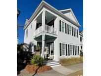 Charming two-story home features white siding, black shutters, and a cozy front porch at 1391 Peterson St., Myrtle Beach, SC 29577