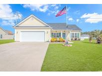 Charming single-story home with a well-manicured lawn and American flag waving proudly at 256 Maple Oak Dr., Conway, SC 29526