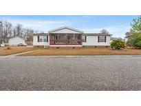 Charming single-story home with a screened-in porch and well-maintained lawn at 287 Kanawha Trail, Longs, SC 29568