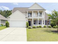 Charming two-story home boasts a welcoming porch, attached garage, and well-manicured lawn at 3000 Chesterwood Ct., Myrtle Beach, SC 29579