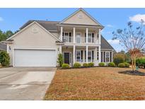 Charming two-story home with a double front porch, well-manicured lawn, and a two-car garage at 3000 Chesterwood Ct., Myrtle Beach, SC 29579