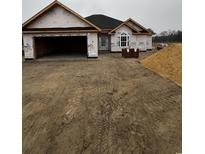 New home construction featuring a two-car garage, covered entrance, and attractive architectural details at 3424 Asbury Rd., Aynor, SC 29511