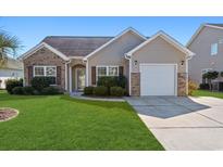 Charming home featuring a well-manicured lawn, brick accents, and an attached one car garage at 422 Cassian Way, Myrtle Beach, SC 29588