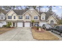 Charming townhomes feature attached garages, manicured lawns, and lovely landscaping at 651 Riverward Dr. # 651, Myrtle Beach, SC 29588