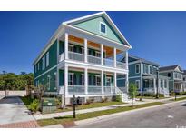 Inviting two-story coastal home with a double porch and manicured landscaping at 8079 Laurel Ash Ave., Myrtle Beach, SC 29572