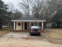 Charming single story home featuring yellow siding, a dark roof and front porch at 901 4Th Ave. N, Myrtle Beach, SC 29577