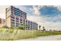 Beachfront condo building with multiple balconies, offering stunning views of the ocean and coastline at 201 77Th Ave. N # 420, Myrtle Beach, SC 29577