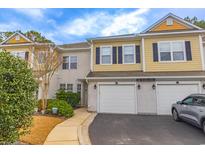 Charming multi-story townhome featuring an attached garage and well-manicured landscaping at 2450 Marsh Glen Dr. # 812, North Myrtle Beach, SC 29582