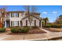 Charming townhome with well-maintained landscaping, manicured shrubbery, and inviting curb appeal at 306 Kiskadee Loop # 4-F, Conway, SC 29526