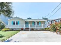 Charming single-story beach home with a cozy front porch, well-manicured lawn, and ample parking space at 317 23Rd Ave. N, North Myrtle Beach, SC 29582