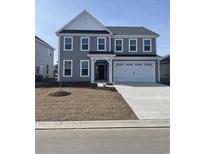 Traditional two-story home featuring a two-car garage, covered porch, and classic architectural details at 351 Broughton Dr., Myrtle Beach, SC 29579