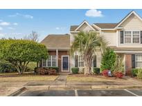 Charming two-story townhome with a well-manicured lawn, lovely landscaping, and a brick facade in a desirable neighborhood at 3567 Chestnut Dr. # 3567, Myrtle Beach, SC 29577