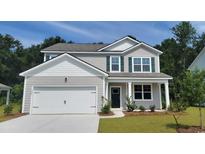 Charming two-story home featuring neutral siding, a two-car garage, green shutters and a well-manicured front yard at 360 Rookroost Circle, Conway, SC 29526