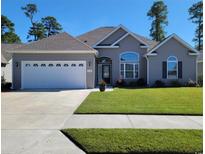 Charming single-story home featuring a two-car garage, well-manicured lawn, and inviting front entrance at 372 Leste Rd., Myrtle Beach, SC 29588