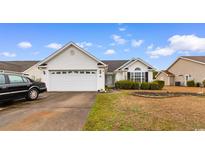 Charming single-story home with manicured lawn, two-car garage, and traditional design at 401 Barton Loop, Myrtle Beach, SC 29579