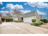 Charming single-story home with attached garage, well-maintained landscaping, and a spacious concrete driveway at 440 Woodpecker Ln. # A, Murrells Inlet, SC 29576