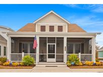 Charming exterior view of a single-Gathering home with a screened front porch, manicured landscaping, and beautiful curb appeal at 8155 Living Tide Dr., Myrtle Beach, SC 29572
