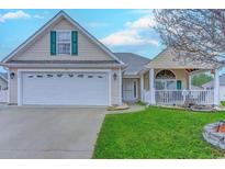 Charming single-story home with a two-car garage, green shutters, covered porch, and well-manicured lawn at 920 Leather Leaf Ln., Longs, SC 29568