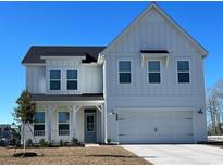 Charming two-story home featuring white siding, a covered porch, and an attached two-car garage at 1292 Safe Haven Dr., Myrtle Beach, SC 29579