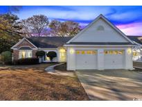 Charming one-story home featuring a brick facade, two-car garage and well-maintained landscaping at 1639 Coventry Rd., Surfside Beach, SC 29575