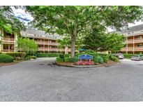 Well-maintained Arrowhead Court entrance with lush landscaping and mature trees at 180 Rothbury Circle # 303, Myrtle Beach, SC 29572