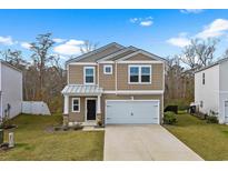 Inviting two-story home showcasing a two-car garage and manicured front lawn at 188 Timber Oaks Dr., Myrtle Beach, SC 29588