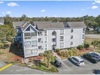 Multi-story condo building featuring well-maintained landscaping and ample parking at 351 Lake Arrowhead Rd. # 2-206, Myrtle Beach, SC 29572