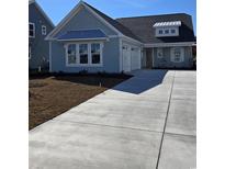 Charming blue craftsman-style home with a two-car garage and freshly laid front lawn at 381 Starlit Way, Myrtle Beach, SC 29579